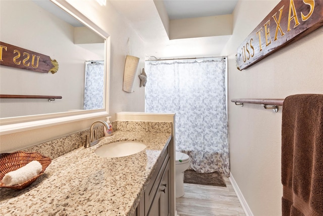 bathroom featuring wood finished floors, vanity, baseboards, toilet, and a shower with shower curtain