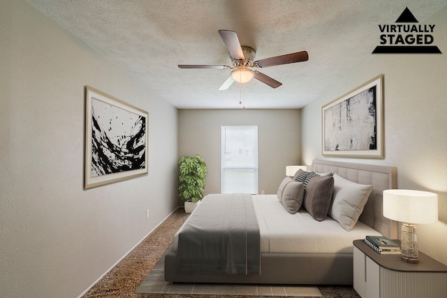 carpeted bedroom with ceiling fan, a textured ceiling, and baseboards