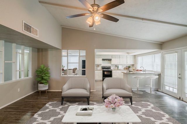 sitting room with vaulted ceiling, baseboards, ceiling fan, visible vents, and wood finished floors