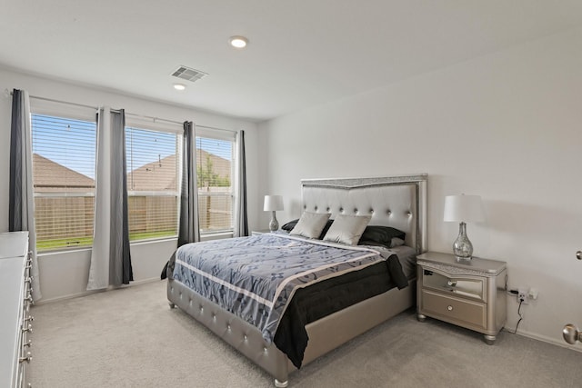 bedroom with light colored carpet, visible vents, recessed lighting, and baseboards