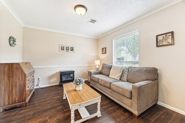 living room featuring baseboards, ornamental molding, a textured ceiling, and wood finished floors