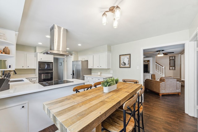 kitchen with open shelves, light countertops, black appliances, island exhaust hood, and a peninsula