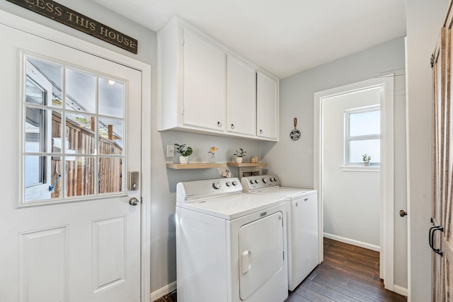 laundry room with dark wood-style flooring, separate washer and dryer, cabinet space, and baseboards