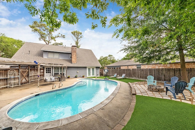 view of swimming pool featuring a patio, a fenced in pool, a fire pit, and a fenced backyard