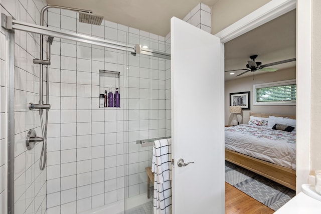 ensuite bathroom featuring recessed lighting, wood finished floors, a ceiling fan, a stall shower, and ensuite bathroom