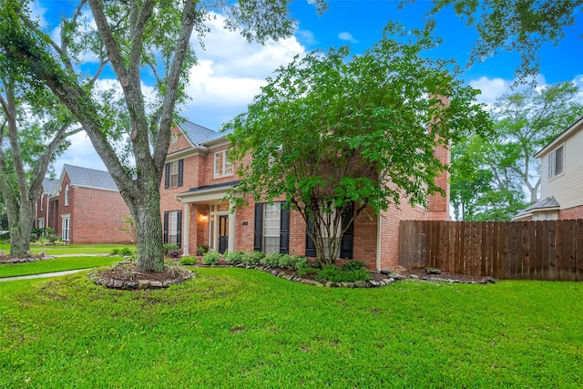1842 Lake Winds, Missouri City, TX 77459 - view of front of house featuring fence, brick siding, and a front yard