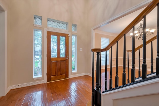 1842 Lake Winds, Missouri City, TX 77459 - entrance foyer featuring a towering ceiling, ornamental molding, baseboards, hardwood / wood-style flooring, and stairs