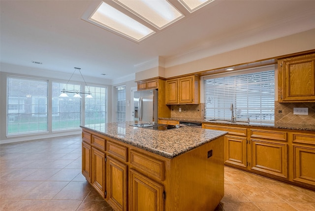 1842 Lake Winds, Missouri City, TX 77459 - kitchen with stainless steel appliances, a center island, brown cabinetry, and light tile patterned flooring