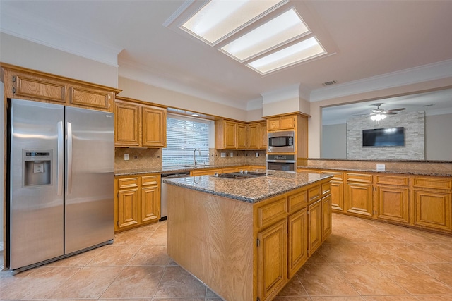 1842 Lake Winds, Missouri City, TX 77459 - kitchen with stainless steel appliances, a center island, a sink, and backsplash