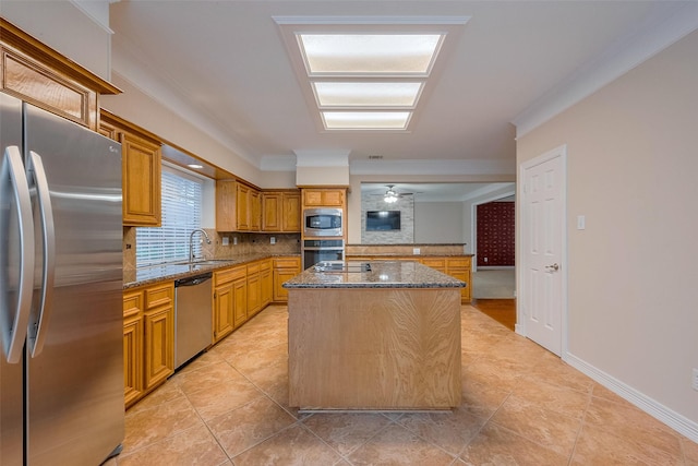 1842 Lake Winds, Missouri City, TX 77459 - kitchen with a center island, a sink, dark stone countertops, decorative backsplash, and appliances with stainless steel finishes
