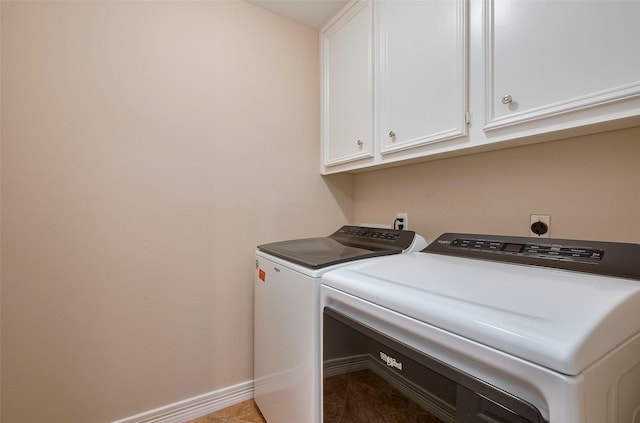 1842 Lake Winds, Missouri City, TX 77459 - laundry area featuring washing machine and clothes dryer, baseboards, light tile patterned floors, and cabinet space
