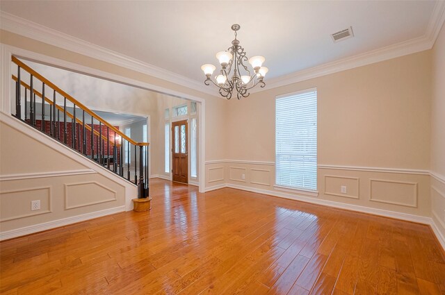 1842 Lake Winds, Missouri City, TX 77459 - unfurnished room with visible vents, light wood-style floors, a chandelier, stairway, and crown molding