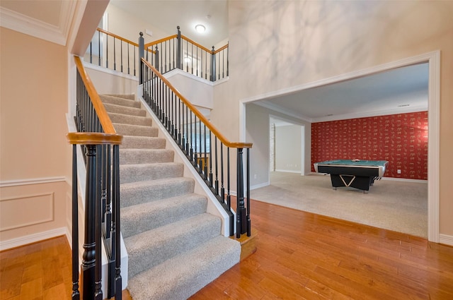 1842 Lake Winds, Missouri City, TX 77459 - stairs featuring wood finished floors, wallpapered walls, billiards, baseboards, and ornamental molding