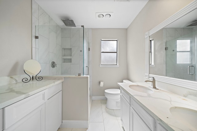 full bathroom with double vanity, a stall shower, and a sink