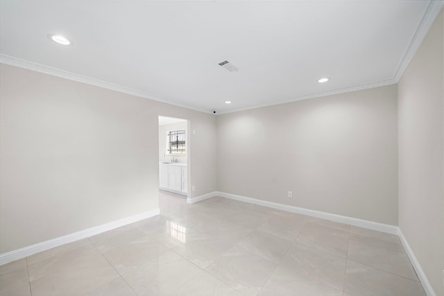 unfurnished room with baseboards, ornamental molding, and visible vents
