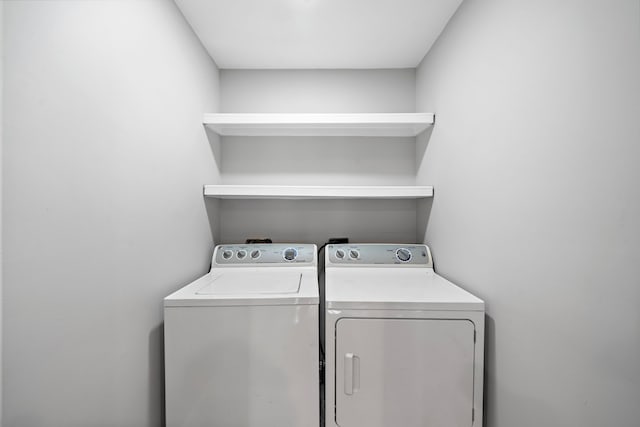 laundry area featuring separate washer and dryer and laundry area