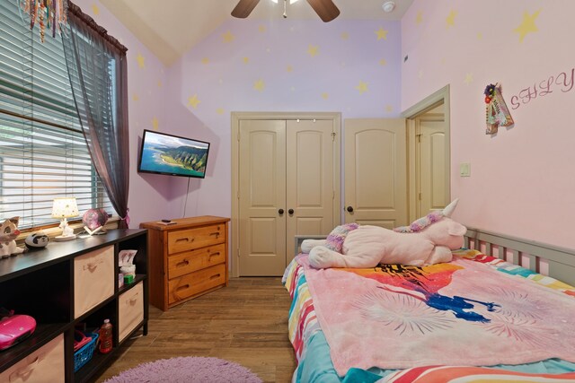 25672 Magnolia Pines Dr, Magnolia, TX 77355 - bedroom with wood finished floors, multiple windows, a closet, high vaulted ceiling, and ceiling fan