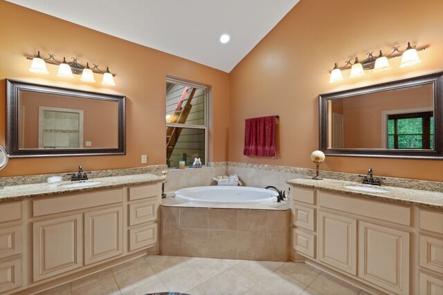 25672 Magnolia Pines Dr, Magnolia, TX 77355 - bathroom featuring vaulted ceiling, two vanities, tile patterned flooring, and a bath
