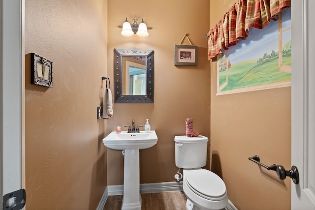 25672 Magnolia Pines Dr, Magnolia, TX 77355 - bathroom featuring wood finished floors, toilet, baseboards, and a sink