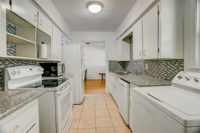 kitchen featuring washer / dryer, tasteful backsplash, white cabinetry, and white appliances