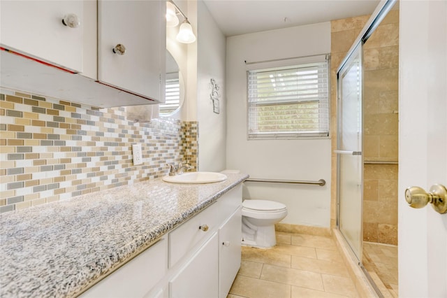 full bath with a stall shower, toilet, tasteful backsplash, tile patterned flooring, and vanity