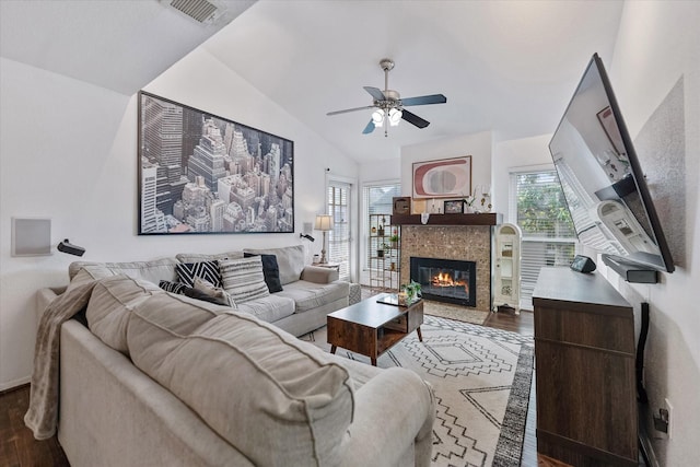1201 Bering Dr Unit 28, Houston, TX 77057 - living area featuring vaulted ceiling, ceiling fan, a fireplace, dark wood-style flooring, and visible vents