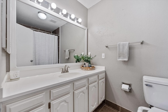 1201 Bering Dr Unit 28, Houston, TX 77057 - bathroom featuring visible vents, tile patterned floors, vanity, and toilet