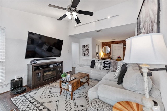1201 Bering Dr Unit 28, Houston, TX 77057 - living area featuring vaulted ceiling, baseboards, visible vents, a ceiling fan, and wood finished floors