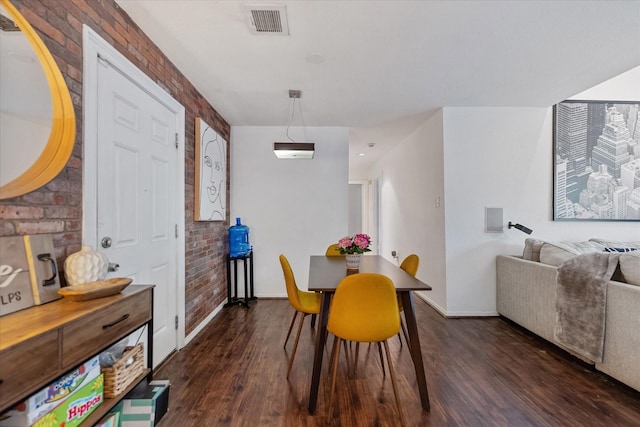 1201 Bering Dr Unit 28, Houston, TX 77057 - dining room with visible vents, brick wall, wood finished floors, and baseboards