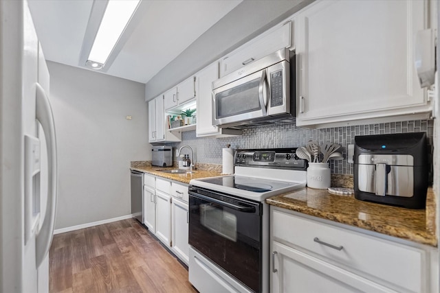 1201 Bering Dr Unit 28, Houston, TX 77057 - kitchen featuring tasteful backsplash, stone countertops, appliances with stainless steel finishes, and a sink