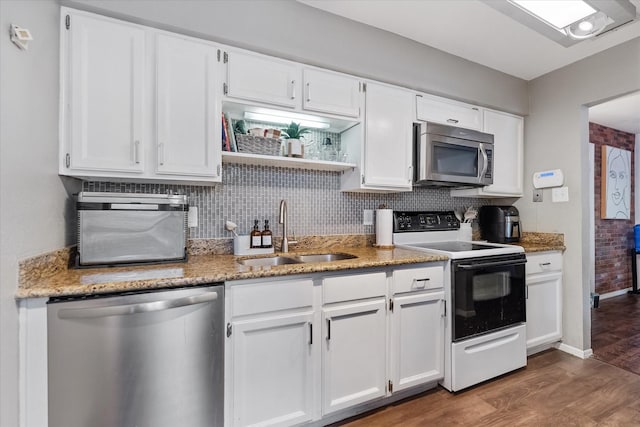 1201 Bering Dr Unit 28, Houston, TX 77057 - kitchen with white cabinetry, stainless steel appliances, dark wood-type flooring, and a sink