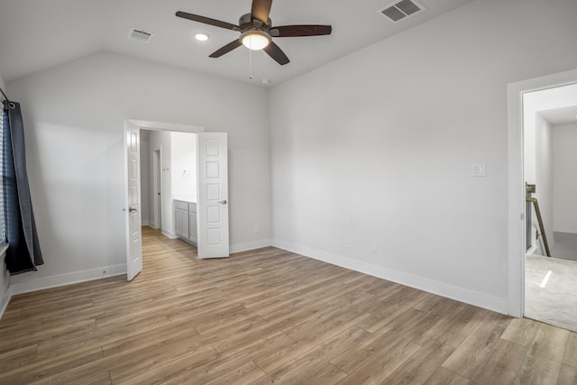unfurnished bedroom with light wood-style floors, lofted ceiling, baseboards, and a ceiling fan