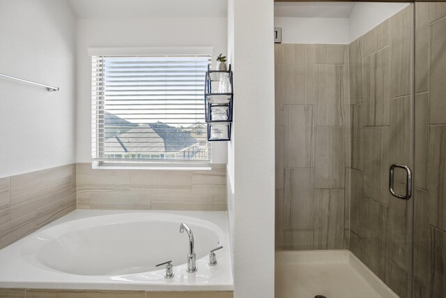 full bathroom featuring a garden tub and a stall shower