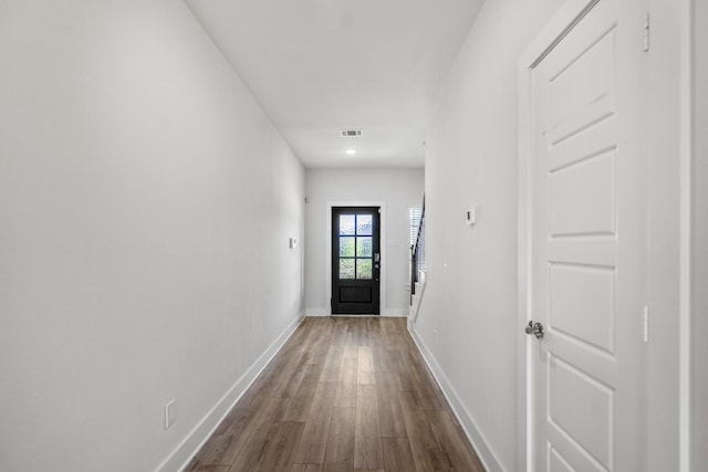 doorway with dark wood-style floors, baseboards, and recessed lighting