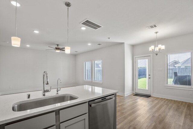 kitchen with a sink, dishwasher, plenty of natural light, decorative light fixtures, and recessed lighting