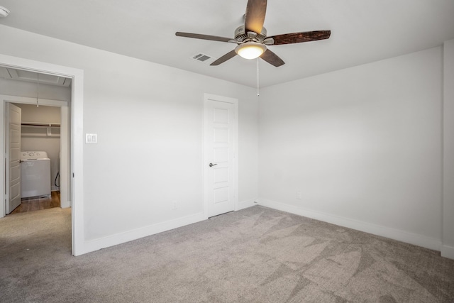 unfurnished bedroom featuring washer / clothes dryer, attic access, carpet flooring, and baseboards