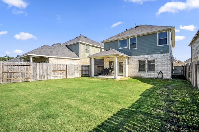 rear view of house with a patio and brick siding