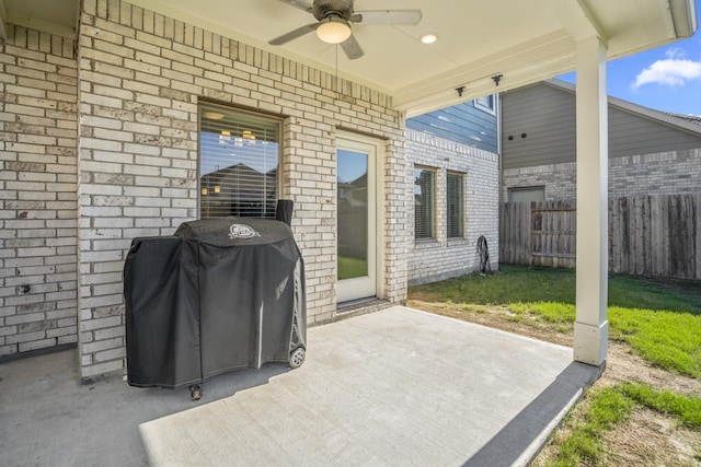 view of patio with ceiling fan, grilling area, and fence