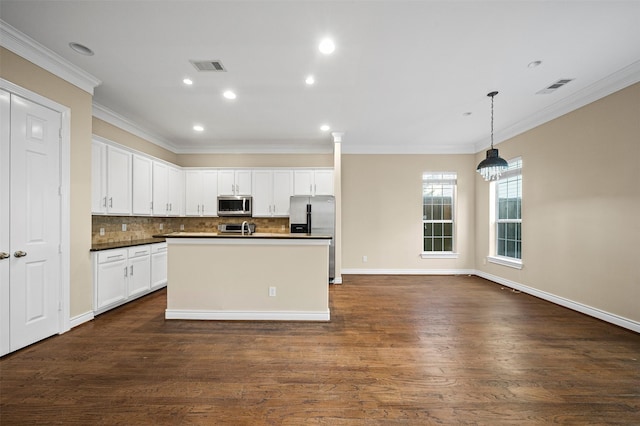 3444 Cline St, Houston, TX 77020 - kitchen featuring stainless steel appliances, visible vents, dark wood-type flooring, and ornamental molding