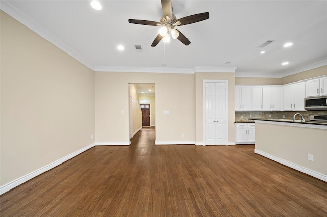 3444 Cline St, Houston, TX 77020 - kitchen with crown molding, a ceiling fan, a sink, stainless steel microwave, and visible vents