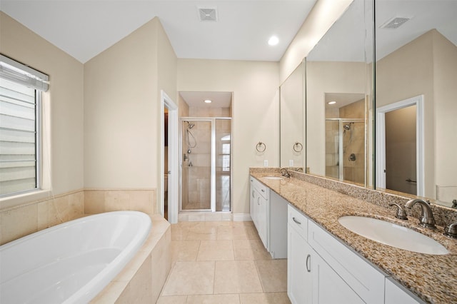 3444 Cline St, Houston, TX 77020 - full bathroom with a sink, double vanity, visible vents, a shower stall, and a garden tub