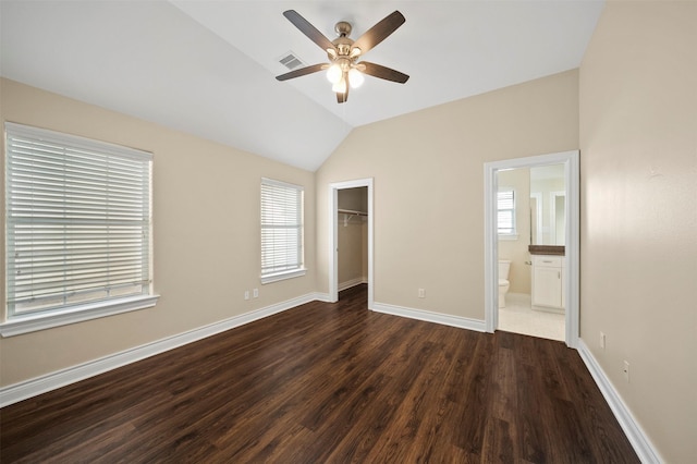 3444 Cline St, Houston, TX 77020 - unfurnished bedroom featuring lofted ceiling, a spacious closet, dark wood-type flooring, a closet, and baseboards