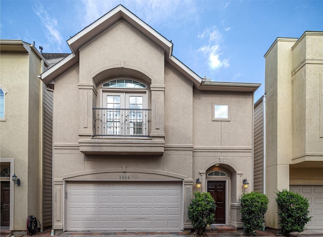 3444 Cline St, Houston, TX 77020 - view of front of property with stucco siding, french doors, a balcony, and a garage