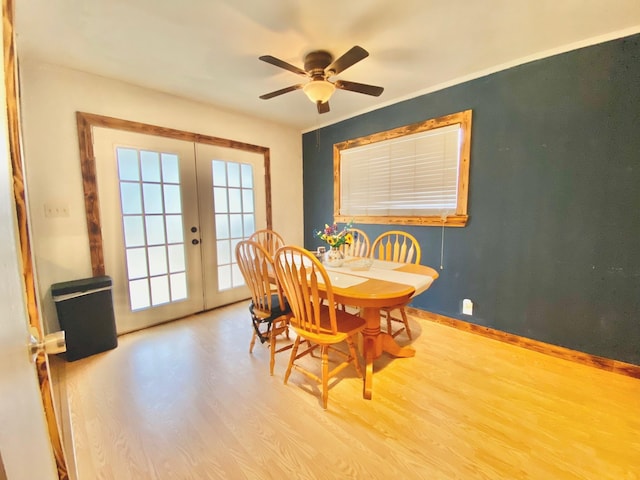 dining room featuring baseboards, french doors, wood finished floors, and ceiling fan