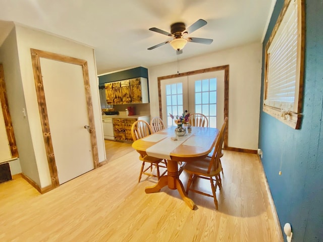 dining area featuring baseboards, a ceiling fan, french doors, and light wood-type flooring