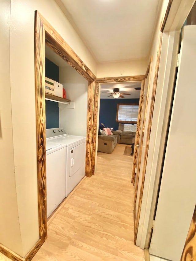 corridor featuring light wood-style flooring and washer and dryer