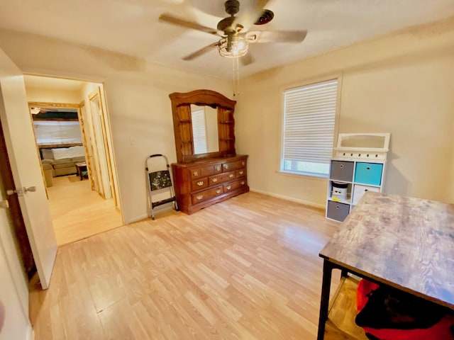 office with ceiling fan, baseboards, and wood finished floors