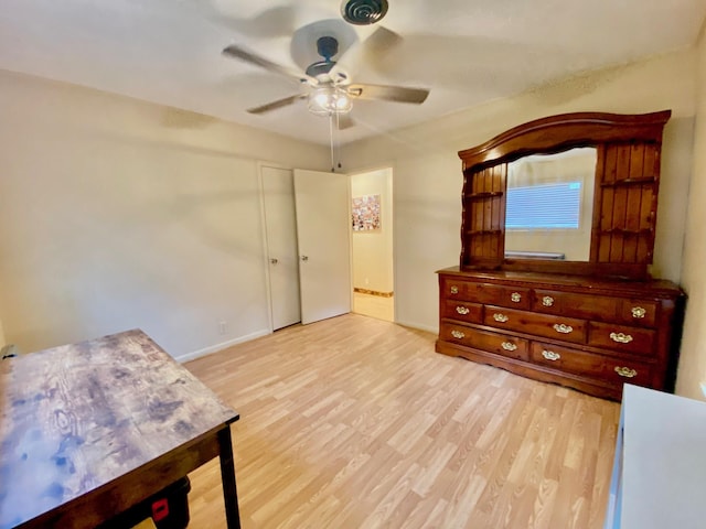 unfurnished bedroom featuring wood finished floors, a ceiling fan, and baseboards