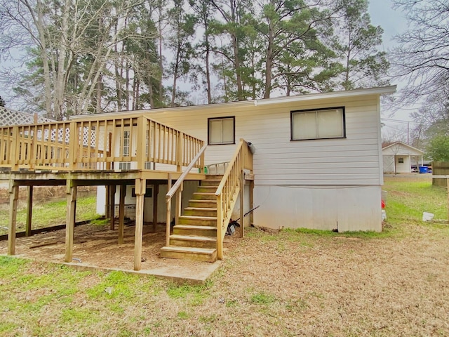 back of house featuring stairway and a wooden deck