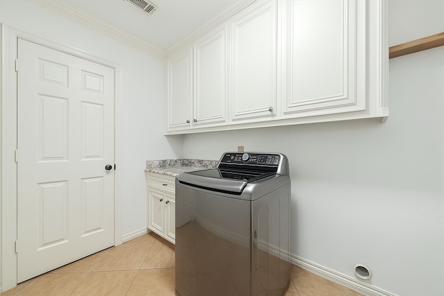 laundry room featuring washer / dryer, cabinet space, visible vents, and light tile patterned floors